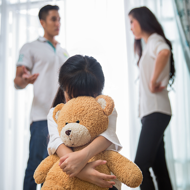 Image of parents having an argument with child present.